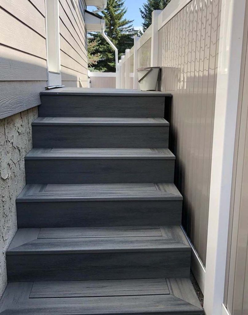 six grey steps leading up to a back door of a house