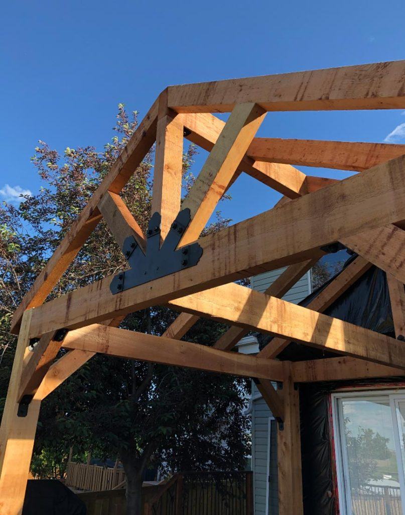 a wooden pergola in a backyard