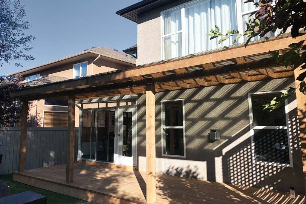 outdoor photo of a backyard deck with a pergola