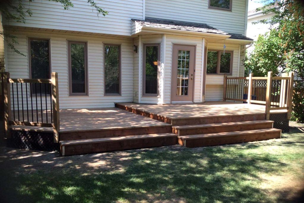 an exterior photo of the back of a house looking at a wooden deck