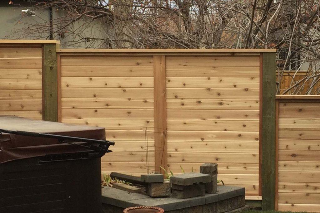 a wooden tiering fence in a backyard