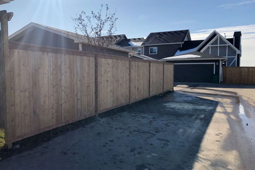 a wooden fence leading up to a house