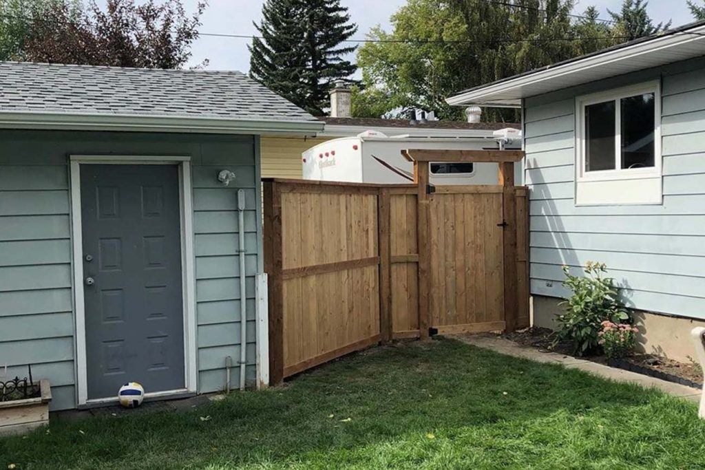 a wooden gate for a backyard